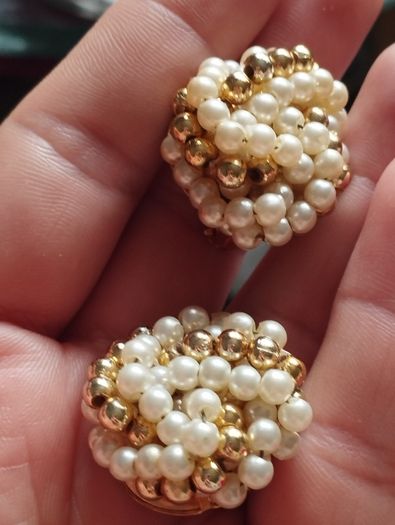 Vintage clip-on earrings with a cluster of faux pearls and gold-tone beads.