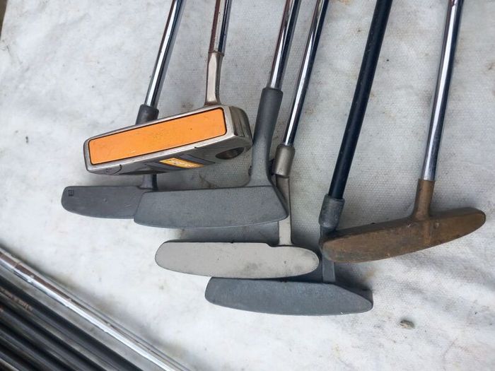 A selection of Golf clubs. Bags and golf balls.