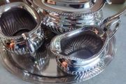 Vintage from the 19th century. Antique Period English Tea Service inc Teapot, Sugar bowl &amp; milk jug Sheffield England on small silver plated tray.