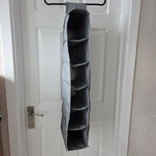 Grey fabric hanging closet organizer with 6 open shelves and side mesh pockets