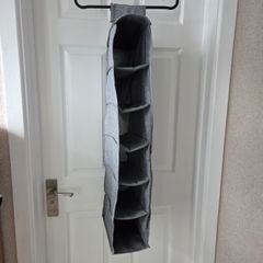 Grey fabric hanging closet organizer with 6 open shelves and side mesh pockets