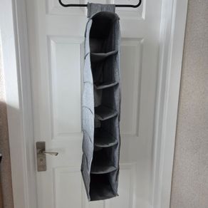 Grey fabric hanging closet organizer with 6 open shelves and side mesh pockets