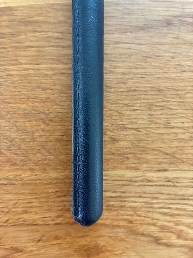 Brand new black leather showing cane
