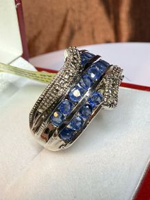 Silver ring with sapphires and diamonds.