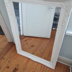 French Baroque/Rococo-style ornate wall mirror with a white painted molded frame