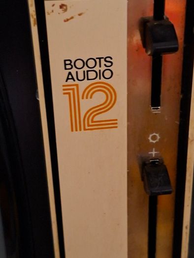 Ideal Prop, Vintage Working Boots Audio TV12 Portable Black and White CRT Television, featuring a cream plastic casing with side control dials and a 12 inch screen. Designed with dual power capabilities supporting standard mains voltage (240V) as well as 