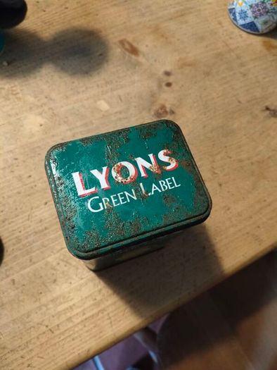 This vintage Lyons Green Label tea tin is a collectible item.