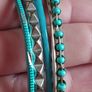 Charming bracelets in silver and blue tones. Image 2