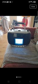 vintage Amstrad CDTV50, a portable boombox featuring a built-in CRT television, radio, and CD player.