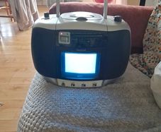 vintage Amstrad CDTV50, a portable boombox featuring a built-in CRT television, radio, and CD player.