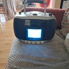 vintage Amstrad CDTV50, a portable boombox featuring a built-in CRT television, radio, and CD player.