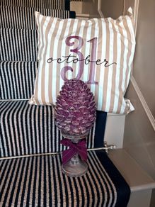 New bespoke oversized autumn Pinecone on distressed wood base in mulberry
