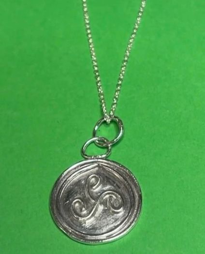 Sterling silver Triskele pendant with 18 inch chain.