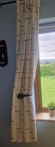 cream heavy curtains with ble & green pattern