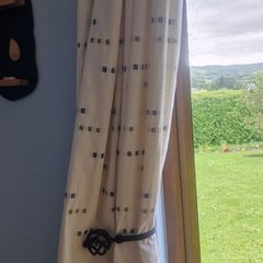 cream heavy curtains with ble & green pattern