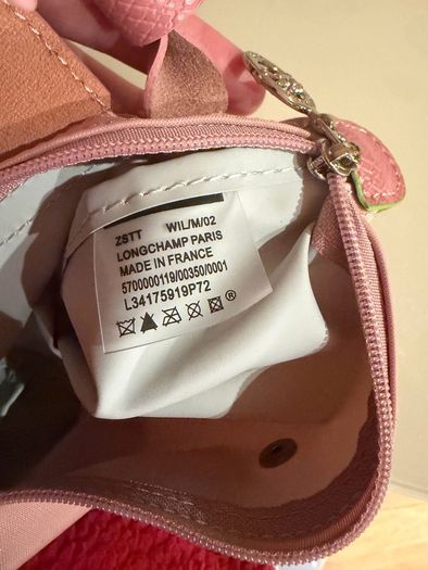 pink Longchamp Le Pliage mini top-handle bag with a detachable shoulder strap