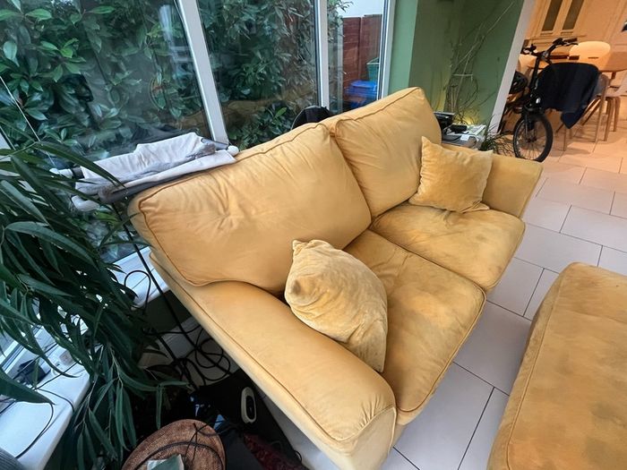 Mustard yellow velvet sofa with matching footstool