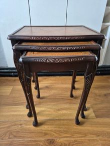 Carved nest of tables with leather top
