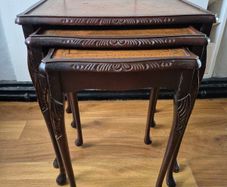Carved nest of tables with leather top