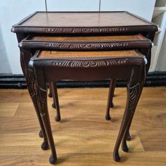 Carved nest of tables with leather top