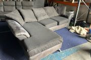 grey/black corner sofa with scatter cushions