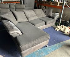 grey/black corner sofa with scatter cushions