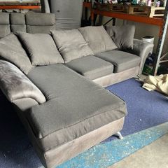 grey/black corner sofa with scatter cushions