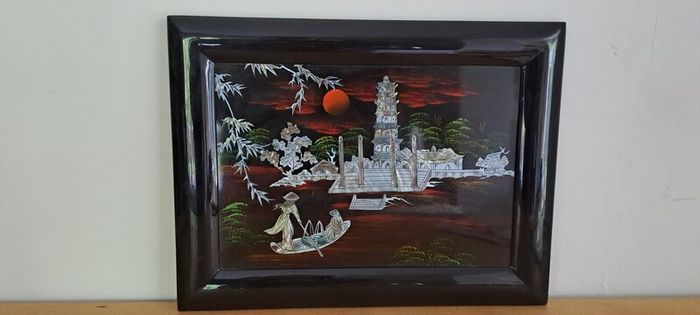 Vintage Vietnamese black lacquer wall plaque featuring intricate mother-of-pearl inlay.