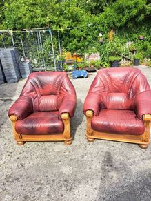 Two large wooden and leather armchairs