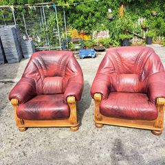 Two large wooden and leather armchairs
