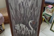Vintage framed needlepoint tapestry depicting a white swan swimming
