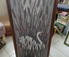 Vintage framed needlepoint tapestry depicting a white swan swimming