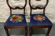 A pair of Victorian mahogany balloon back chairs with tapestry seats.