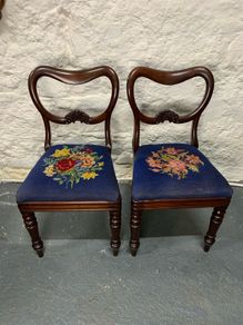 A pair of Victorian mahogany balloon back chairs with tapestry seats.