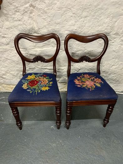 A pair of Victorian mahogany balloon back chairs with tapestry seats.
