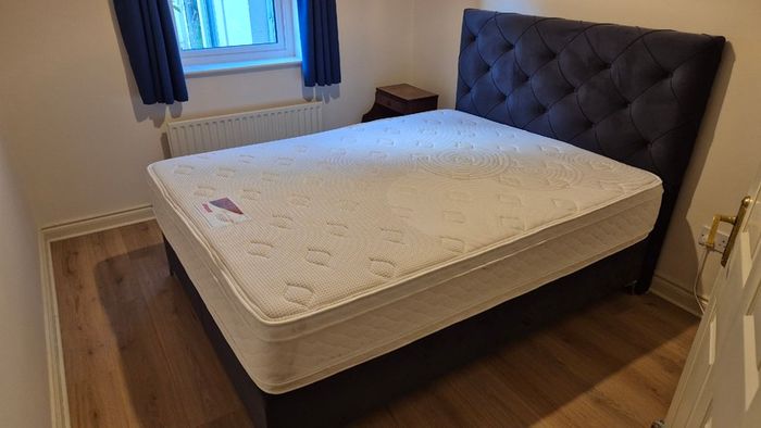 King size ottoman storage bed with navy velvet headboard