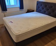 King size ottoman storage bed with navy velvet headboard