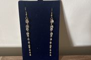 Long gold tone sparkling earrings