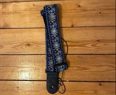 Blue leather bound patterned guitar strap