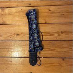 Blue leather bound patterned guitar strap