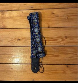 Blue leather bound patterned guitar strap
