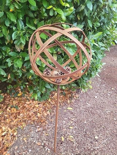 Corten steel garden sphere on a stem