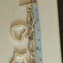 A fashionable bracelet with silver-tone charms. Image 3
