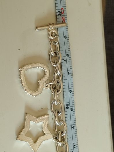 A fashionable bracelet with silver-tone charms.
