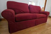 Living room / lounge couch in dark burgundy red