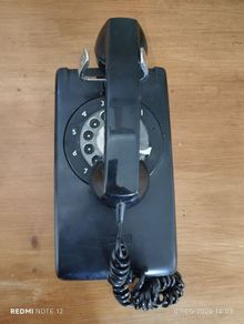Wall Mounted P&T Black phone.