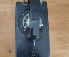 Wall Mounted P&T Black phone.