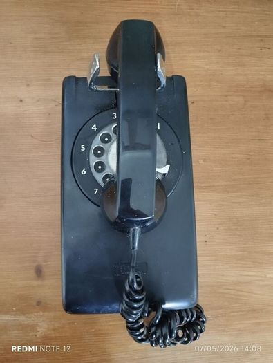 Wall Mounted P&T Black phone.