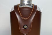 Vintage whiskey flask in brown leather case