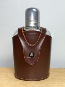 Vintage whiskey flask in brown leather case